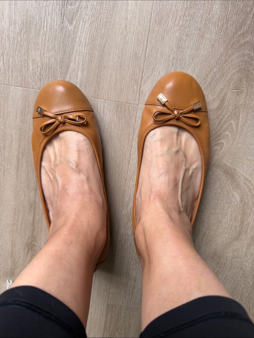 A Pair of Vionic Women's British Tan Ballet Flats with Bow Accent in size 7